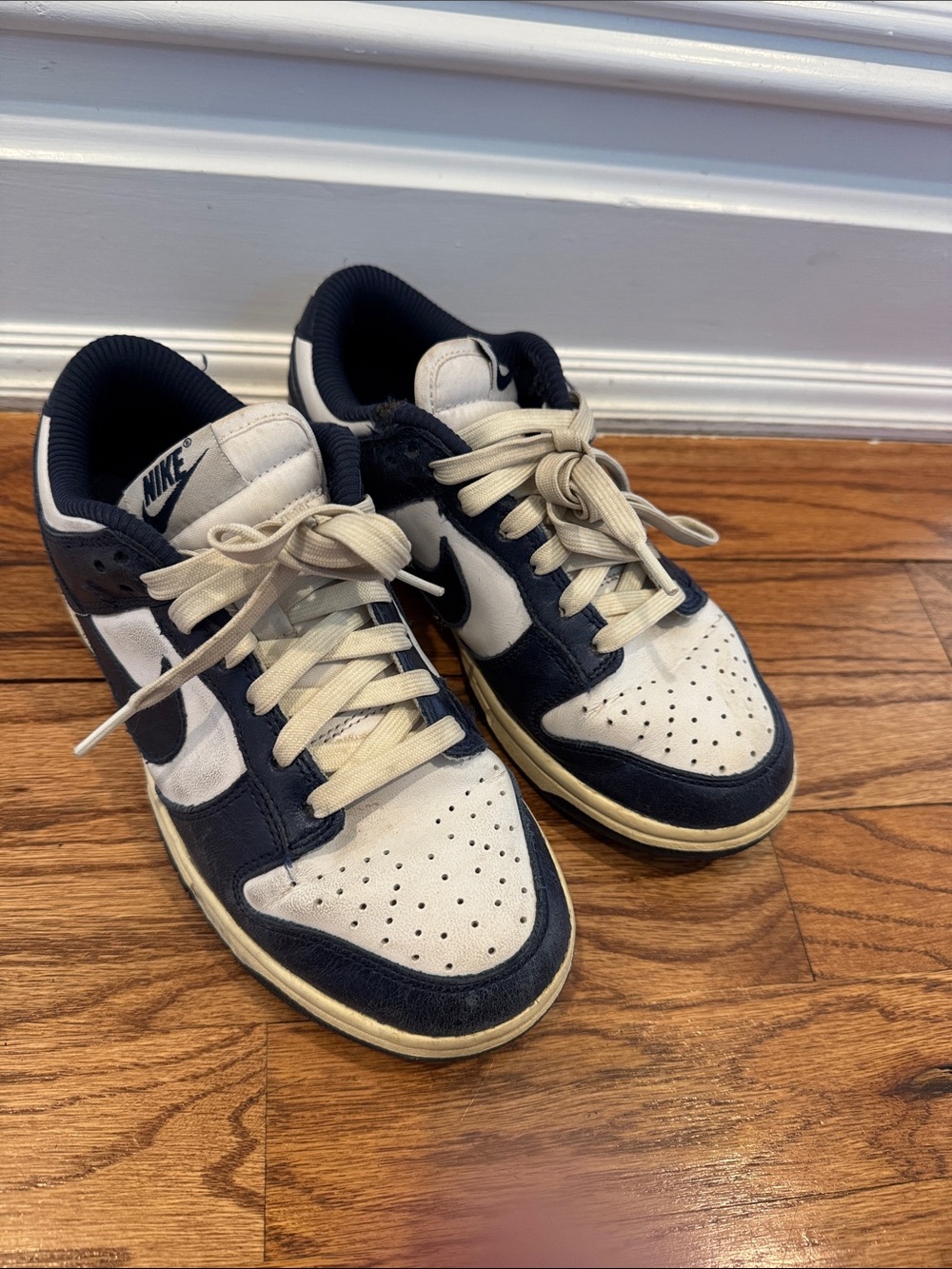 Nike women’s Dunk Low-Top Sneakers in Navy and Cream